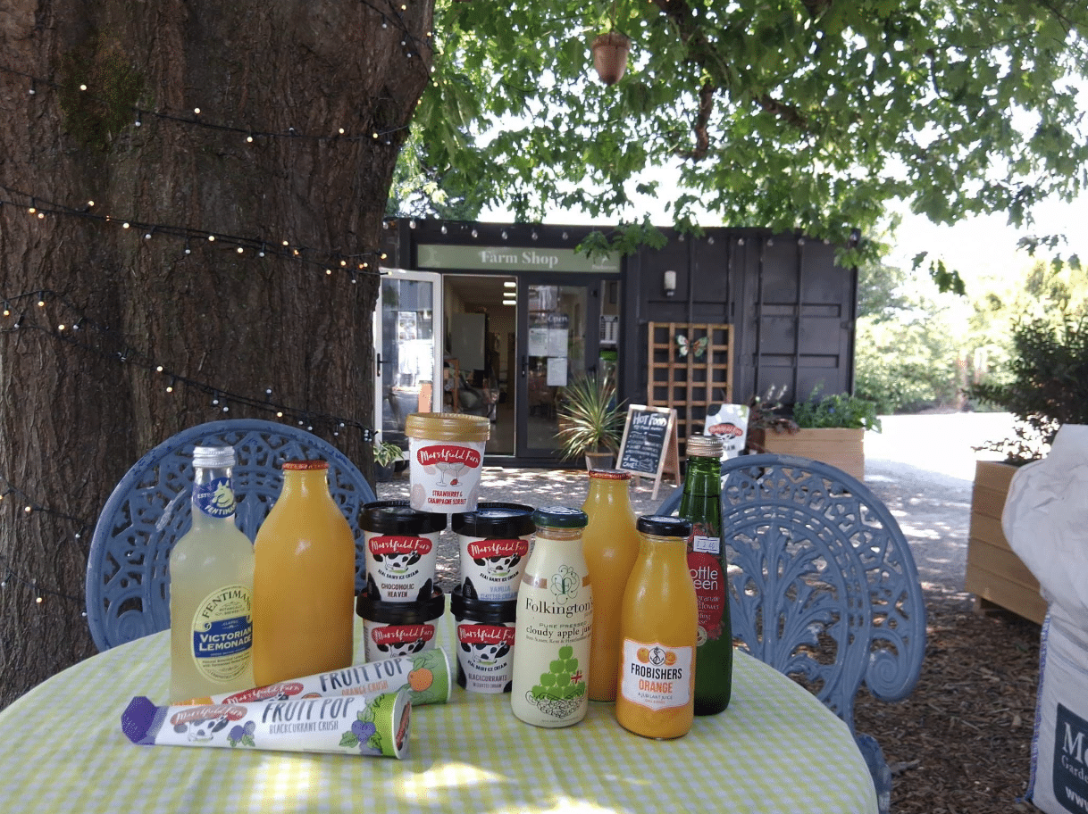 Jackie's Country Larder Farm Shop at Buckovers near Thornbury displaying local drinks, Marshfield Farm Ice Cream and artisan produce outside the farm shop.