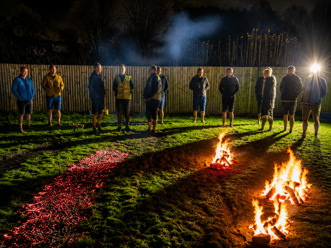 Participants gathered beside the glowing ember firewalk at Buckovers for the GWAAC Mission Ignition event
